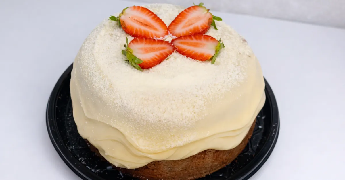 Receita bolo caseiro para vender de morango com brigadeiro branco e decoração de morangos frescos.